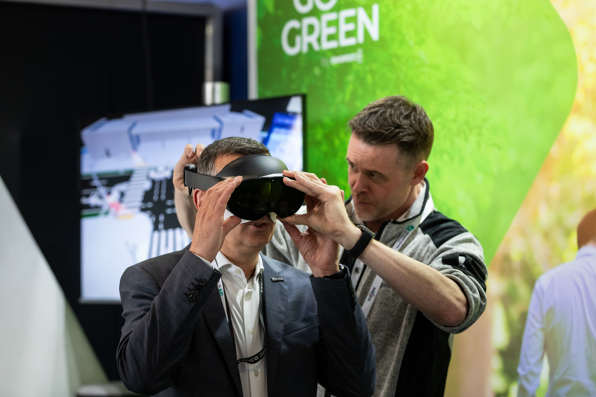 A man in a suit trying VR goggles at the ITS European Congress